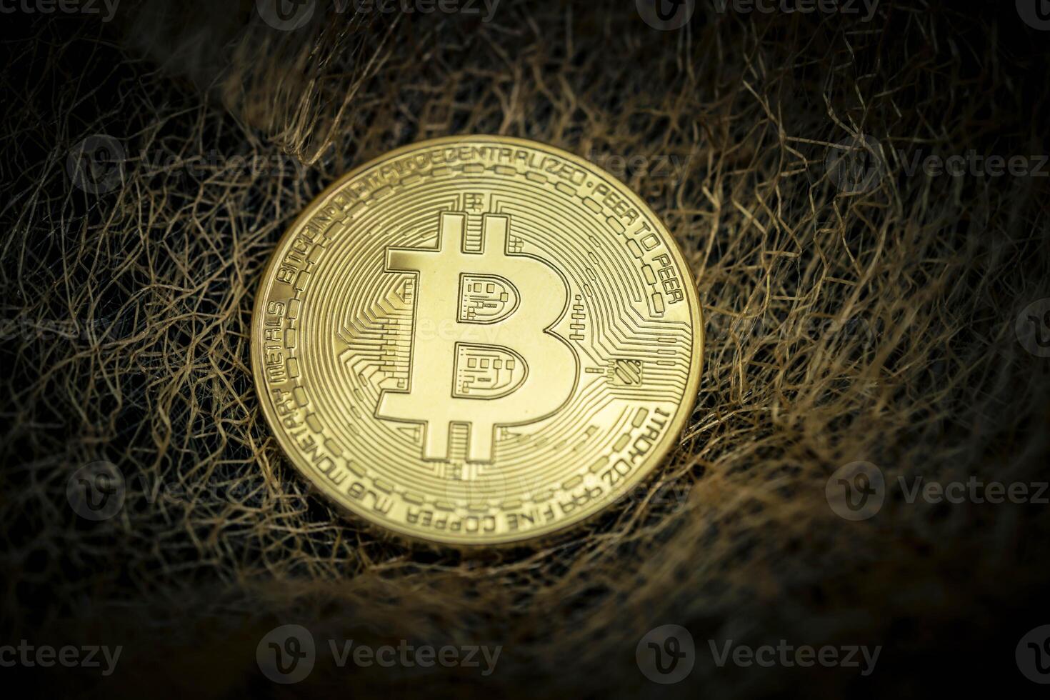 Bitcoin on a fleece of gold threads photo