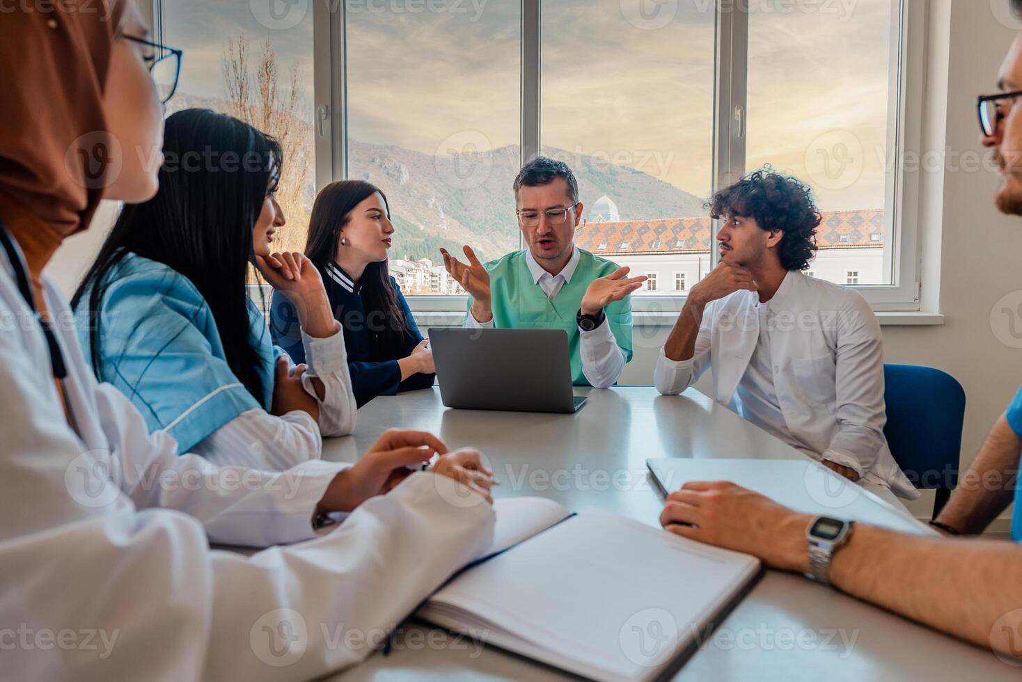 A medical team of doctors discussing at a meeting in the conference room, planning strategy. photo