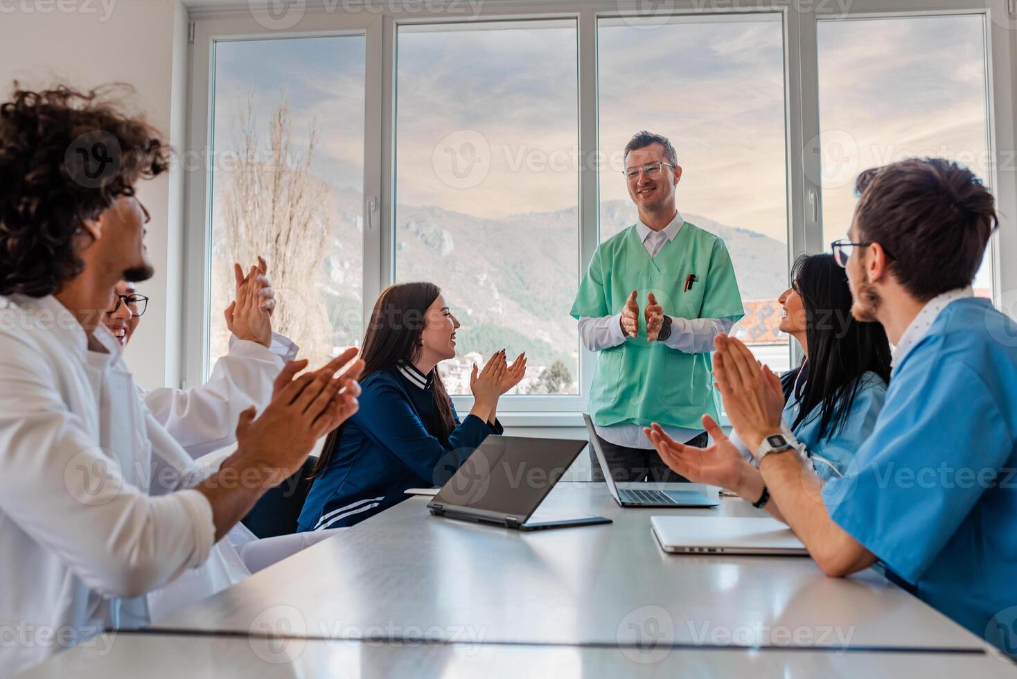 A medical team of doctors support and applause in celebration at the meeting in the office concept of teamwork leadership. photo