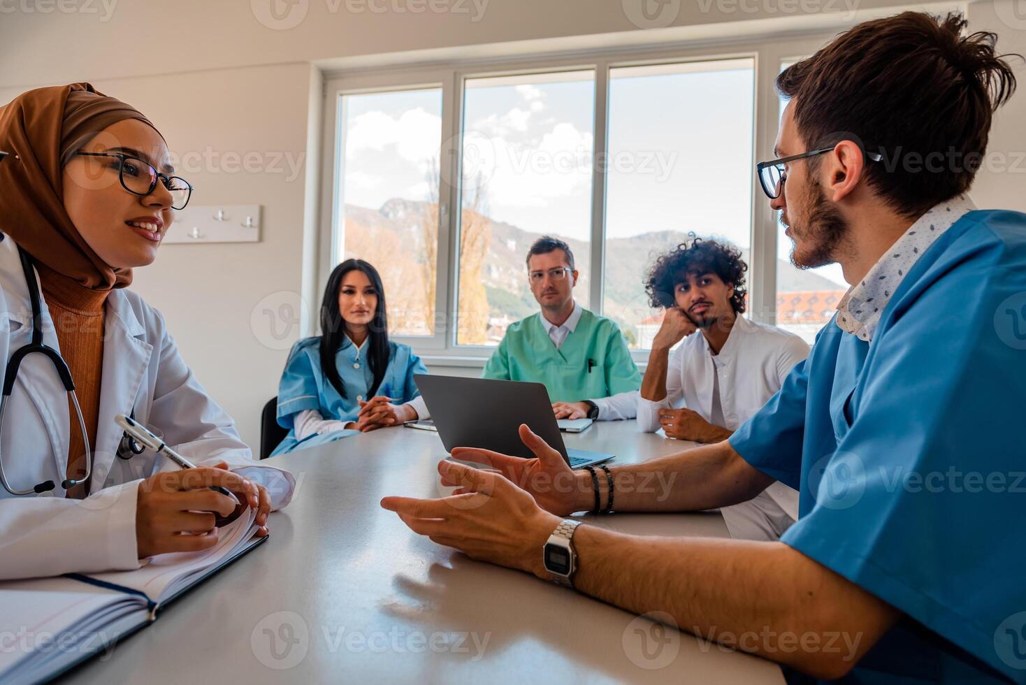 A medical team of doctors discussing at a meeting in the conference room. photo