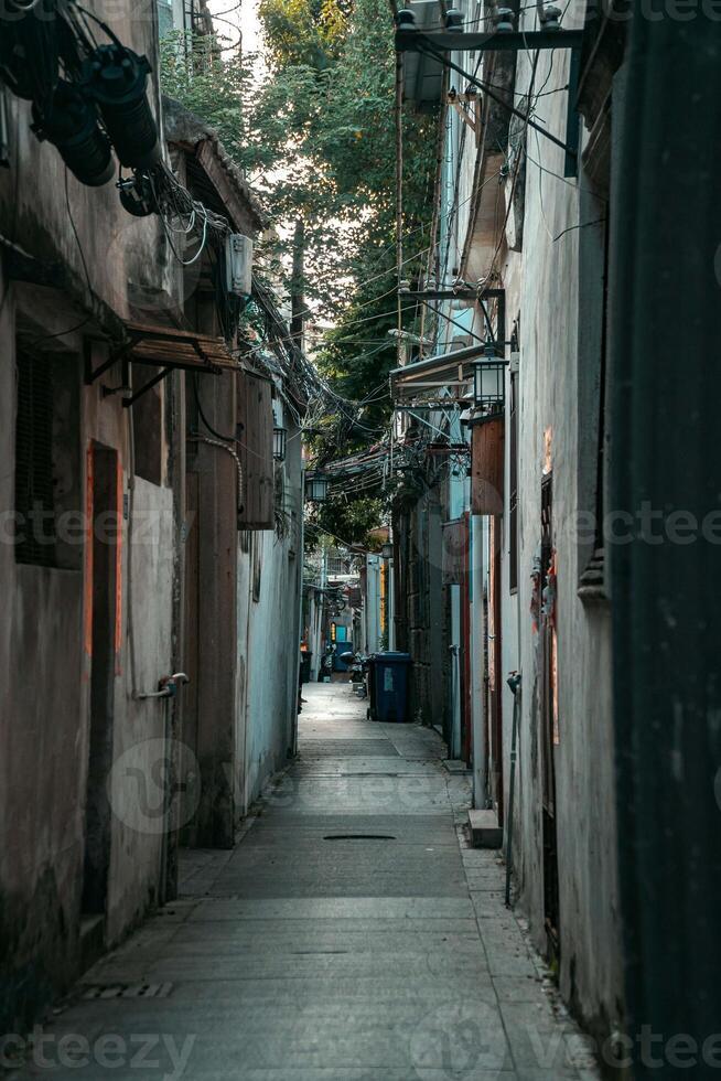 A tranquil and quiet urban alleyway beautifully illuminated in soft, ambient light photo