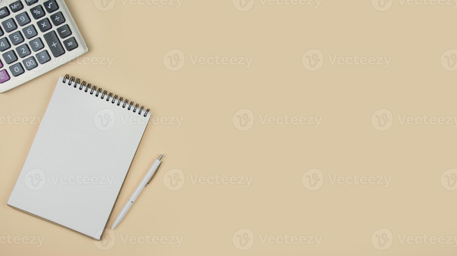 Notepad and calculator on a light background. Office tools. The concept of business and education. Copy space. Banner. photo