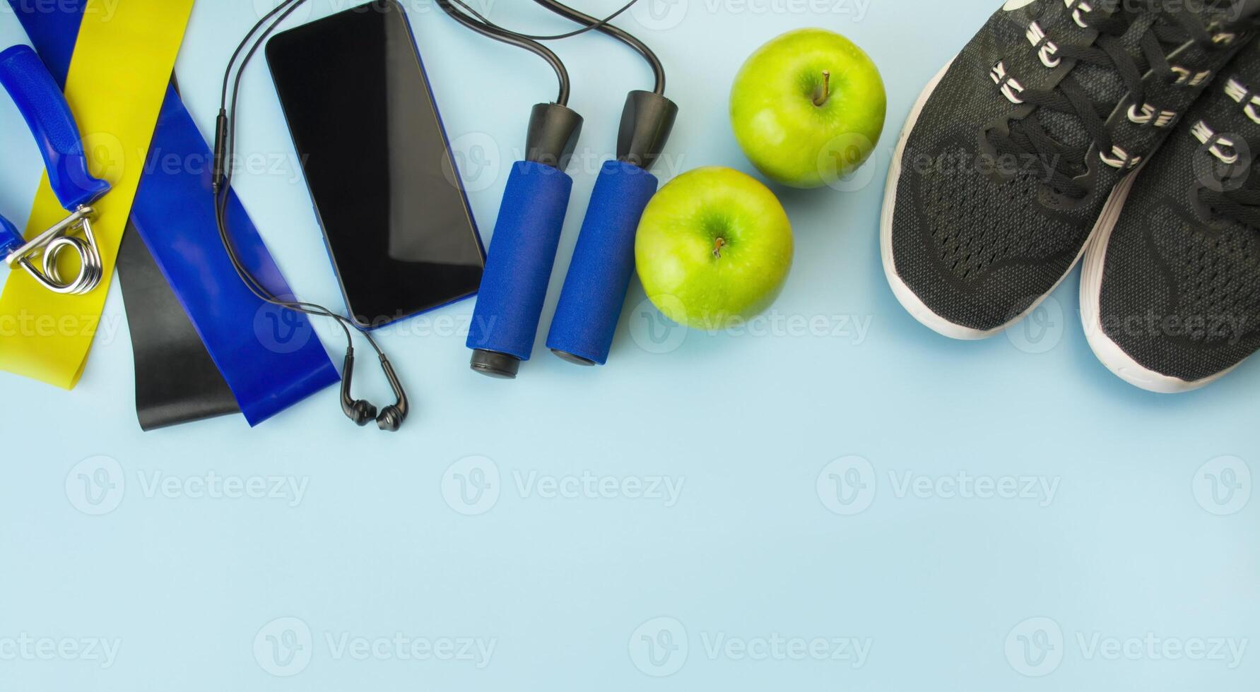 Healthy lifestyle. Sports equipment on a light background. Sport concept. The apartment was lying. Top view with copy space. photo