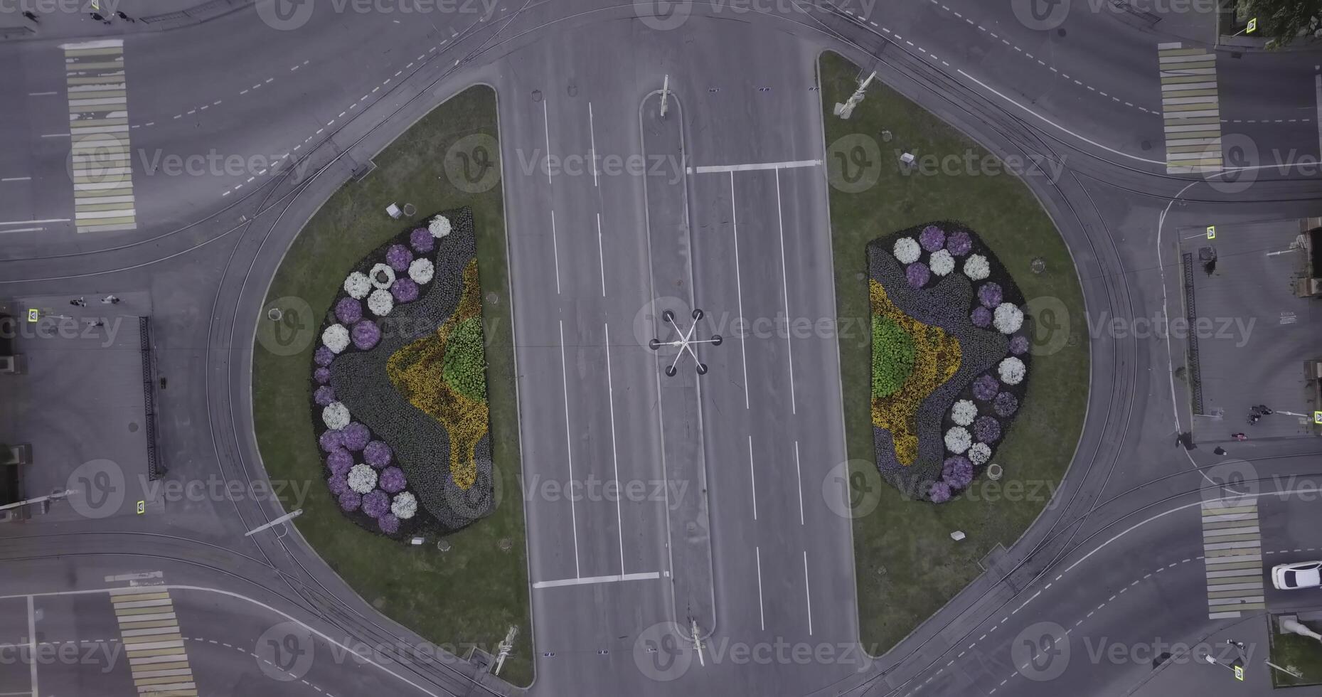 Aerial view of a beautifully designed flowerbed roundabout with various decorative designs. Stock Clip photo