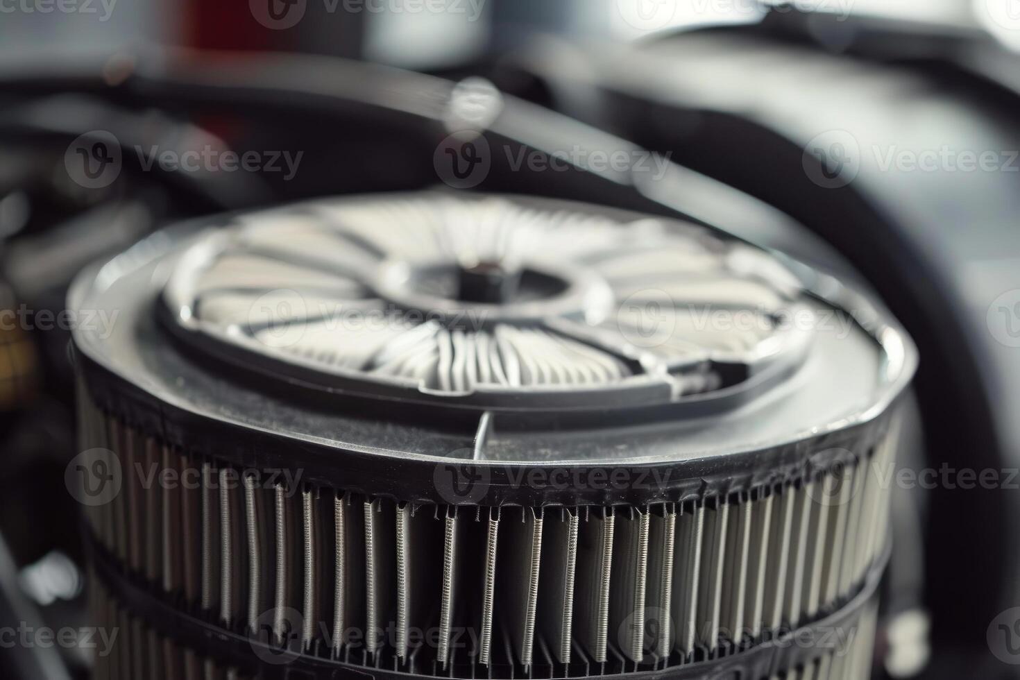 Round car air filter being inspected during maintenance work photo