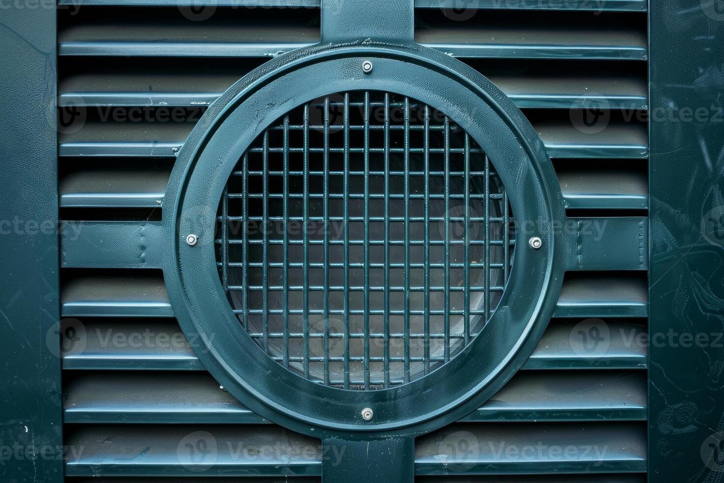 Circular metal grate protecting ventilation system of building photo