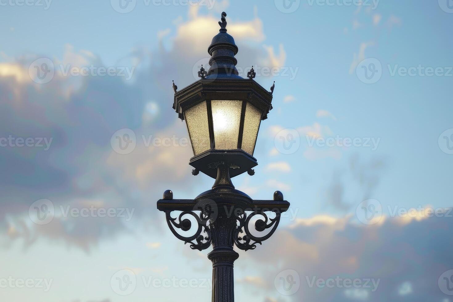 Ornate street lamp standing against a cloudy sky photo