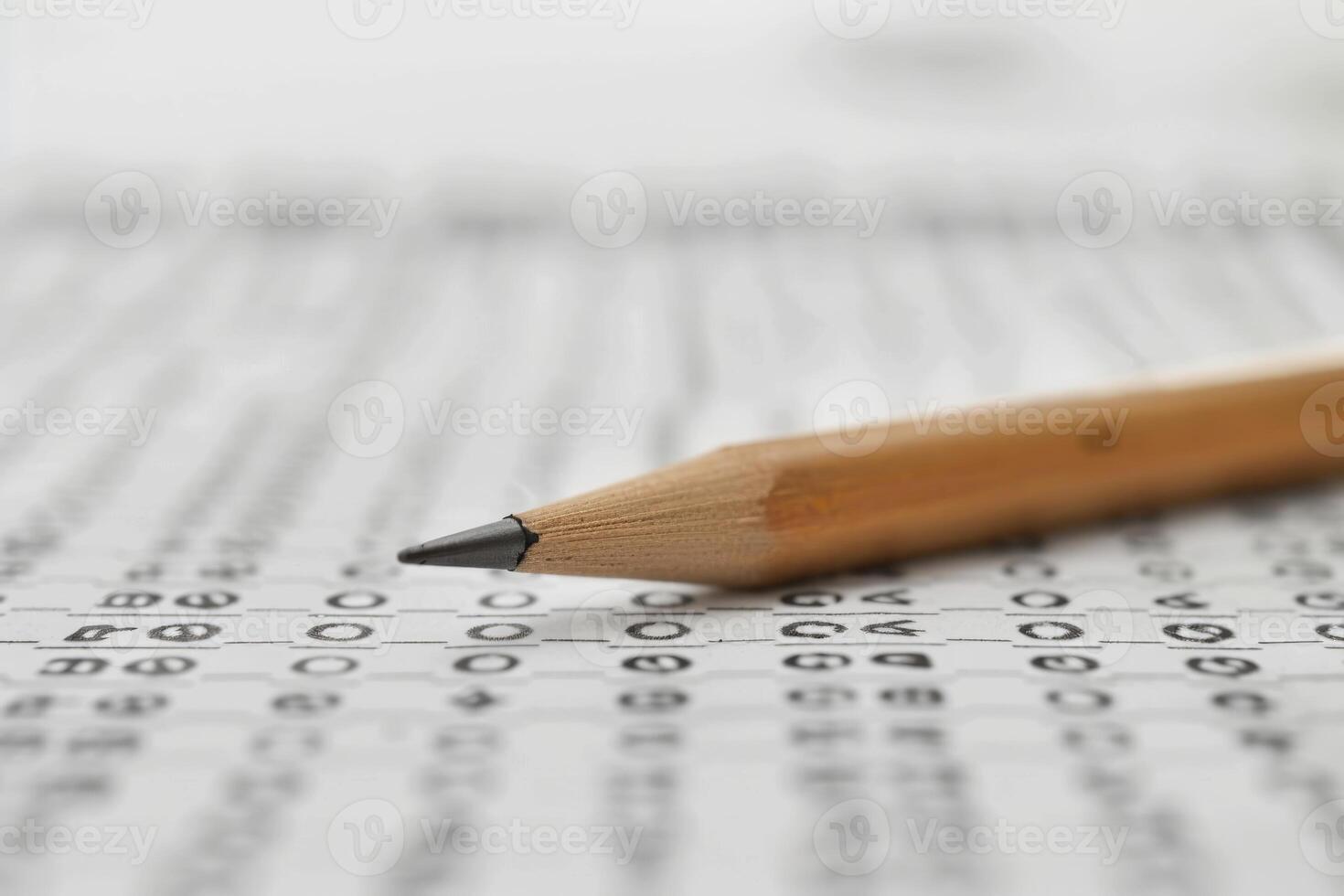 Close up of pencil point resting on scantron test form photo