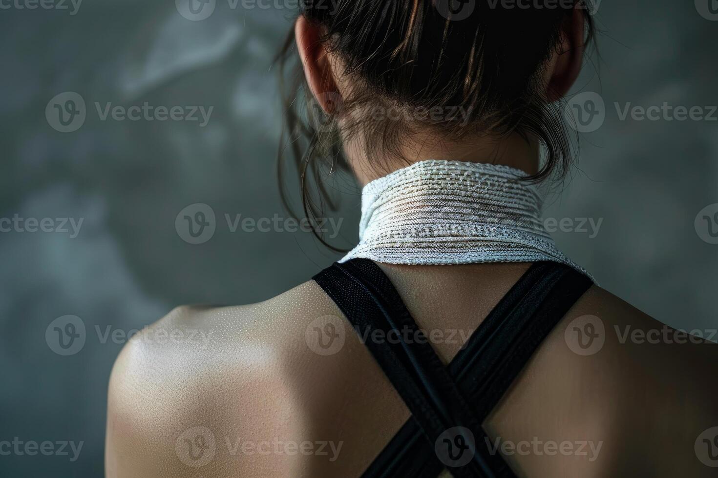 Woman wearing neck brace posing with bare back photo