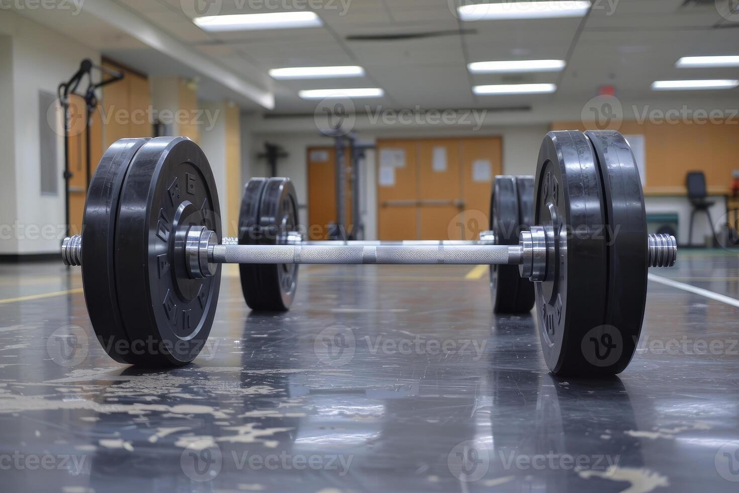 Weight bar with weights lying on a gym floor photo