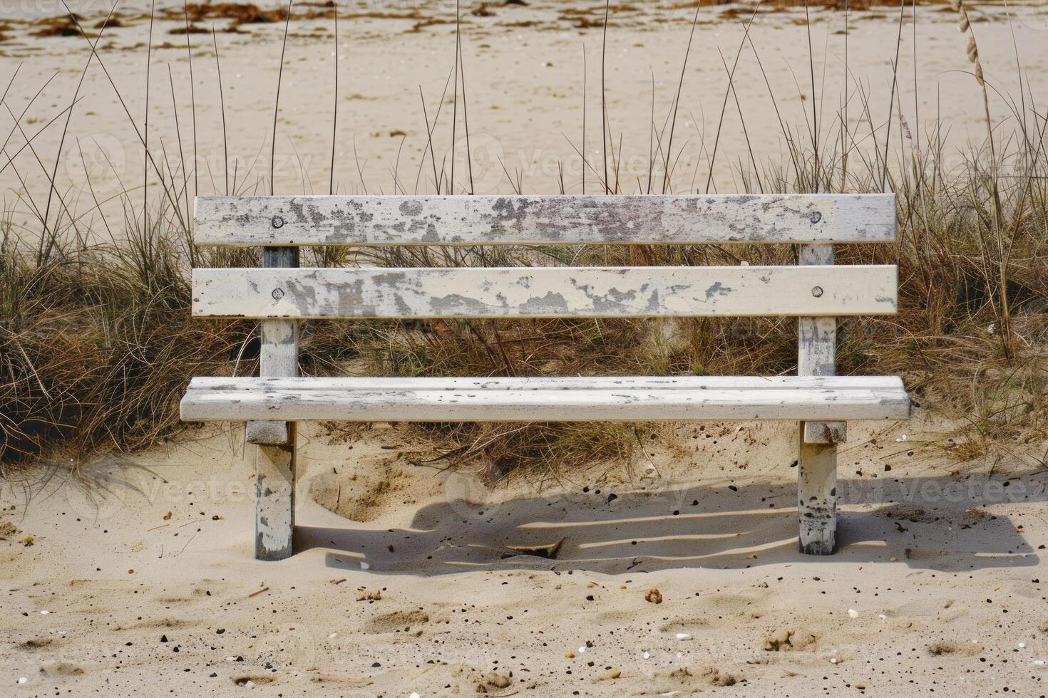Empty bench standing on a sandy beach photo