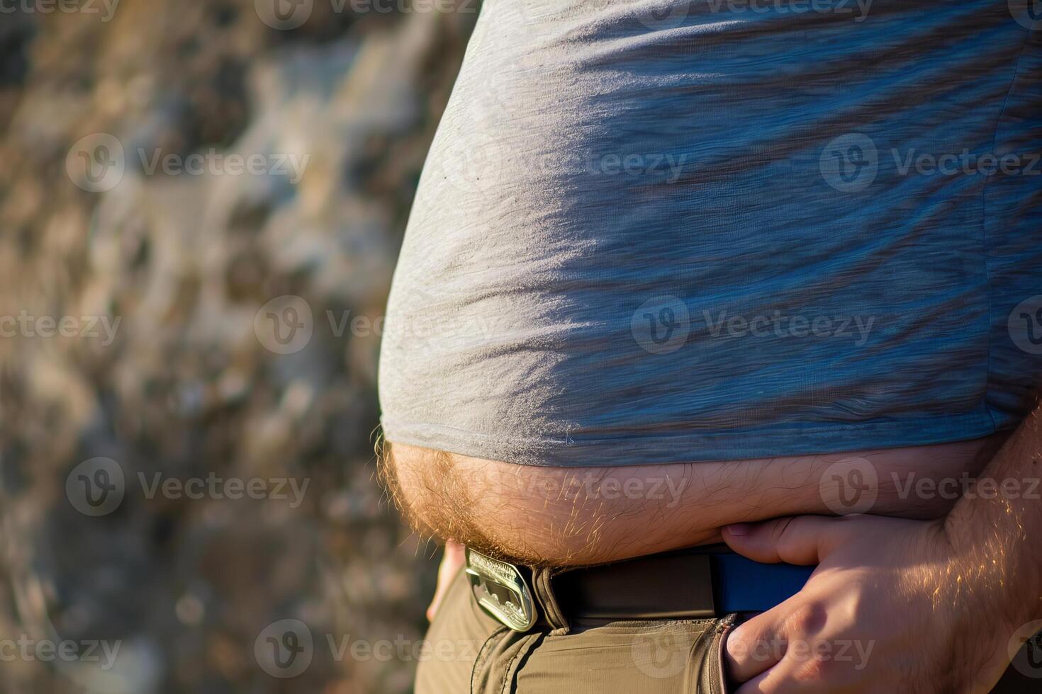 Overweight man showing big belly fat, obesity and unhealthy lifestyle concept photo