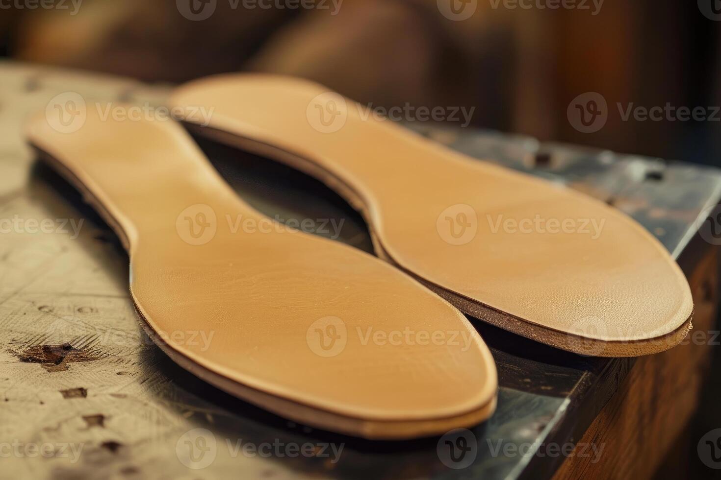 Shoemaker preparing leather insoles for handmade shoes photo