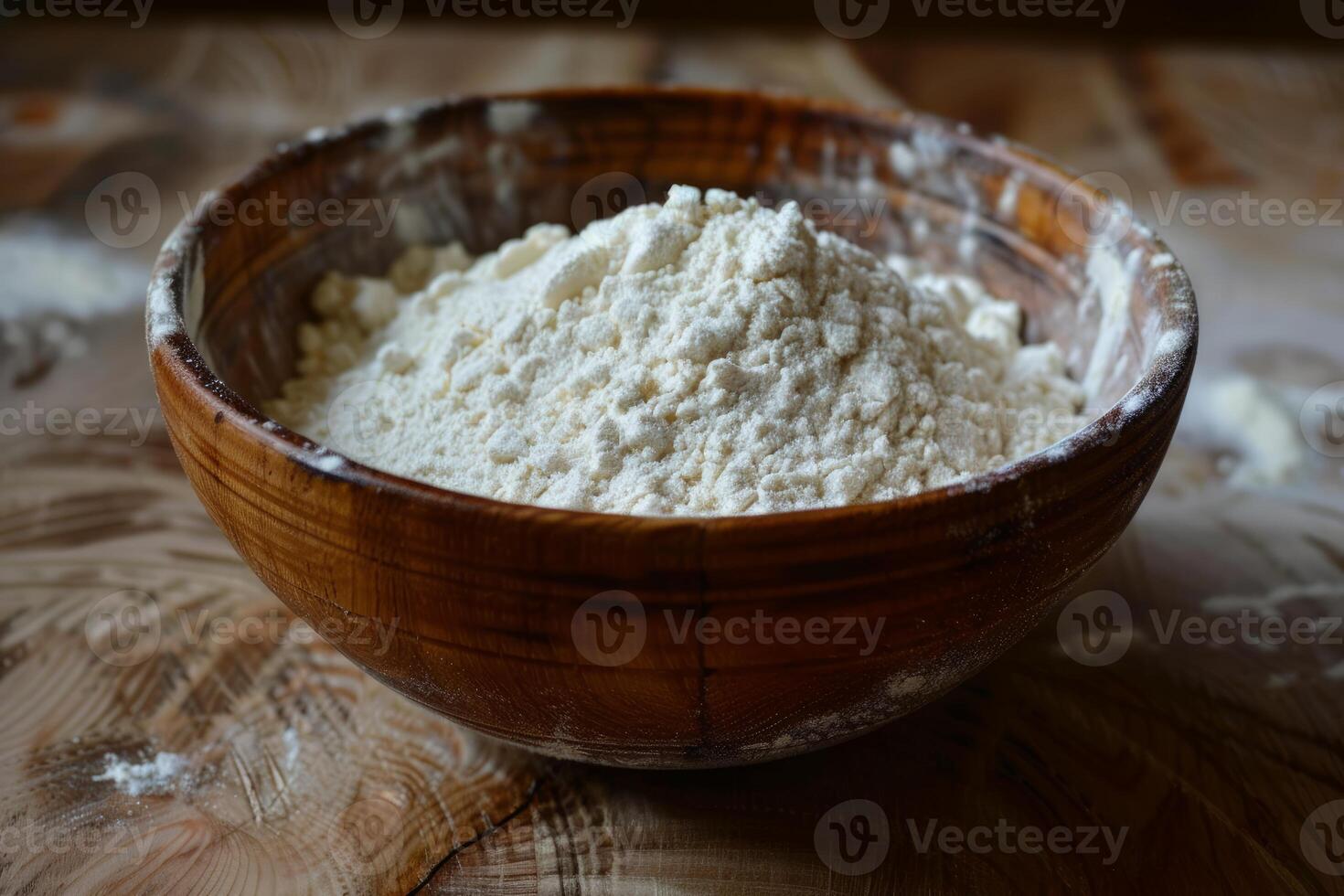 Wooden bowl overflowing with fresh white flour on rustic table photo