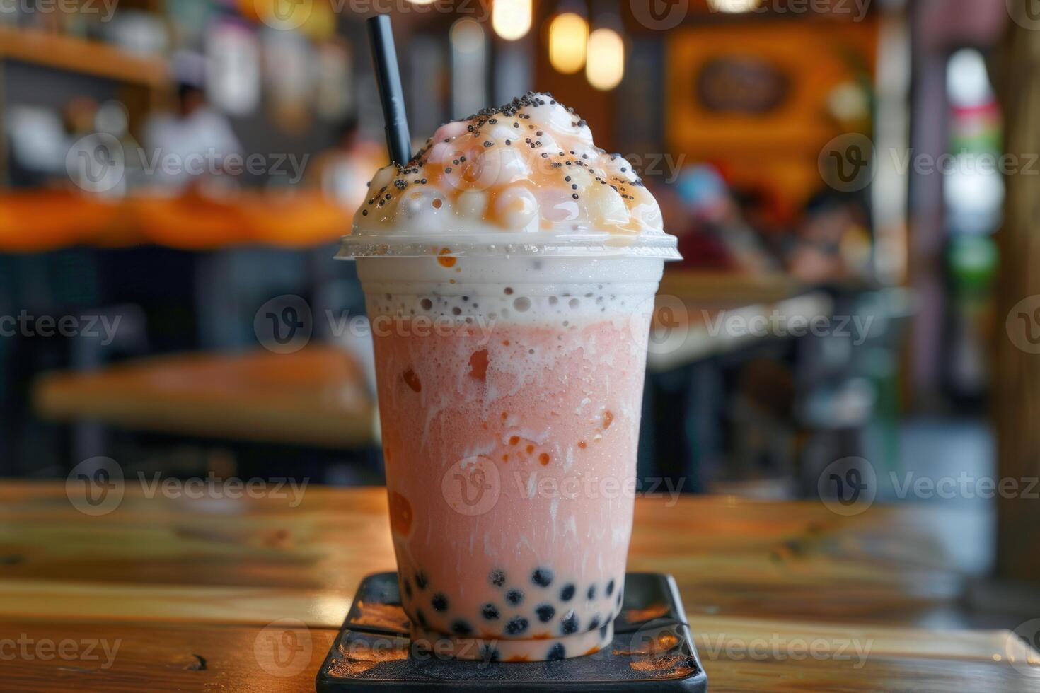 Refreshing boba milk tea with whipped cream and toppings in cafe setting photo