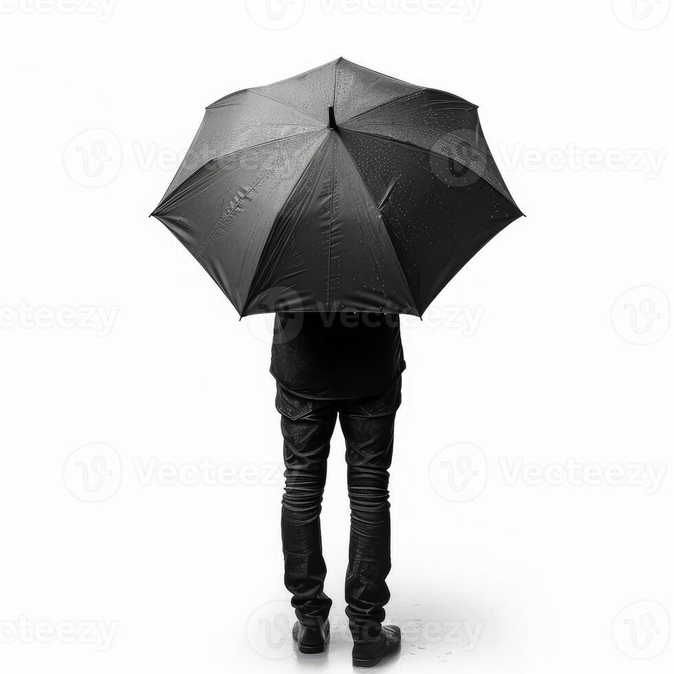 Businessman standing with black umbrella in the rain, rear view photo