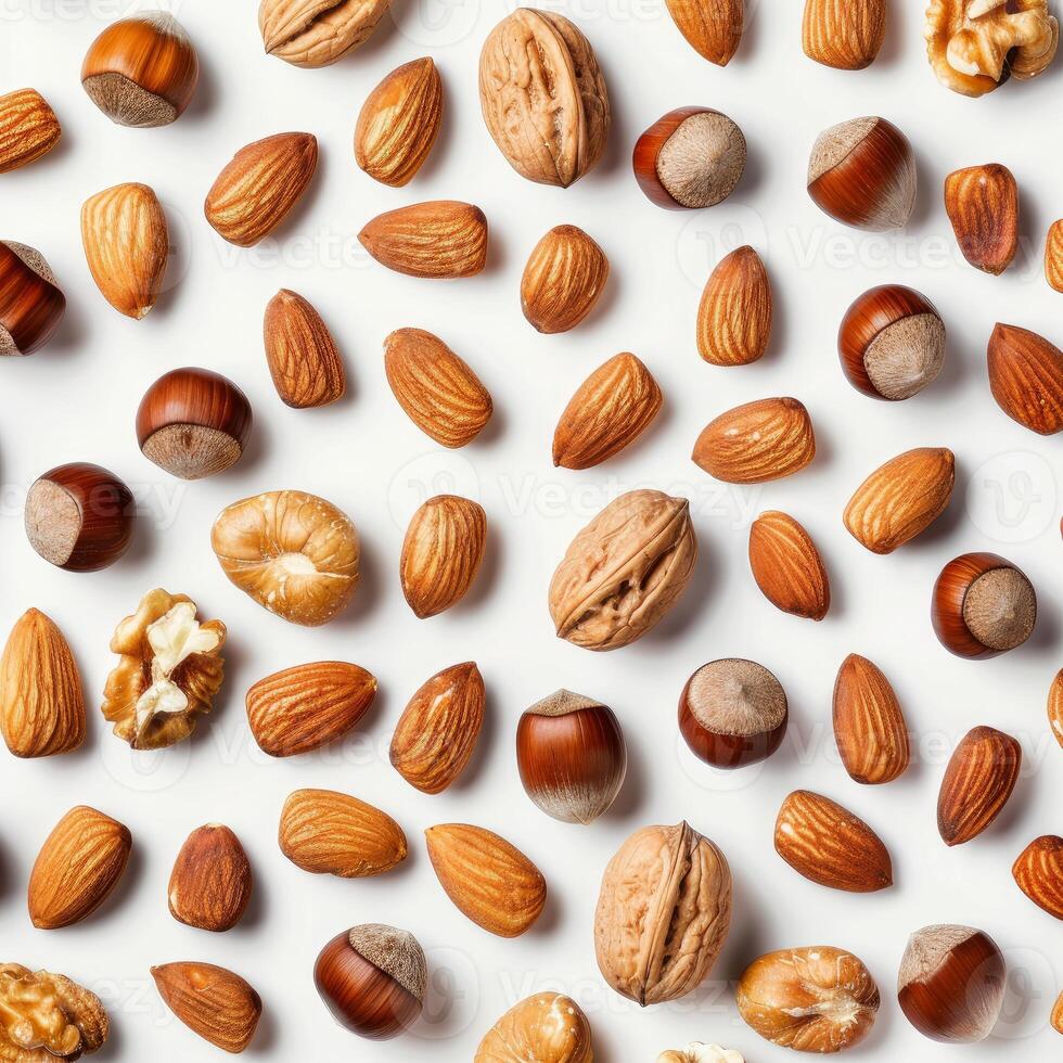 Mixed nuts forming a pattern on white background photo