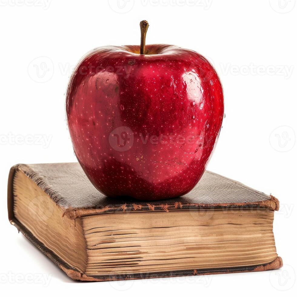Red apple sitting on top of an old book symbolizing education photo