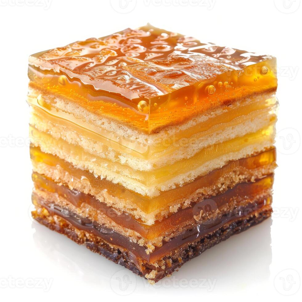 Delicious multi layered cake with golden jelly topping on white background photo