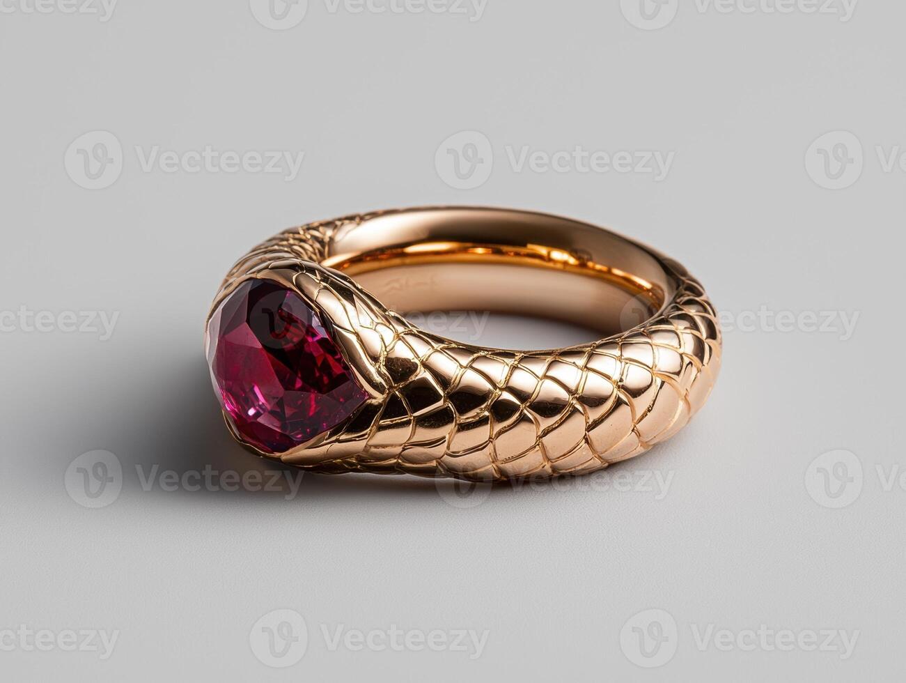 Close up of a ruby gemstone ring with a snake like design photo