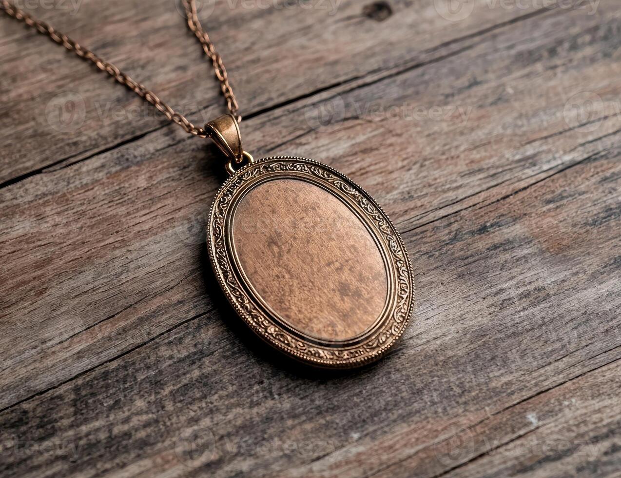 Antique bronze oval locket pendant on wooden background photo