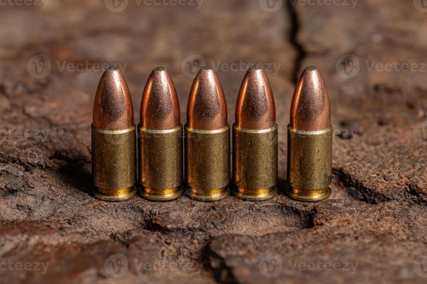 Five bullets on a rustic wooden surface photo