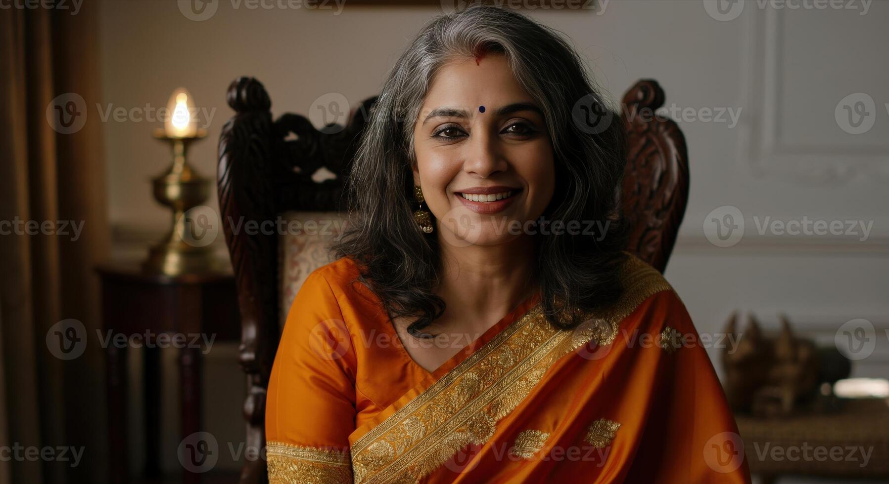 Elegant mature indian woman in traditional sari with cultural decor setting indoors photo
