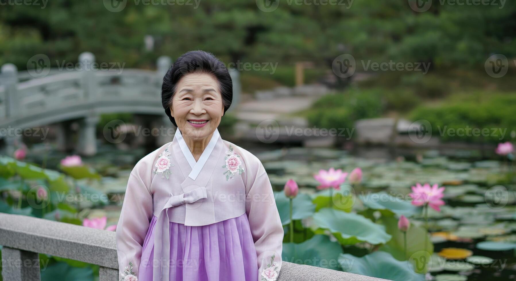 Elderly asian woman in traditional hanbok by lotus pond in peaceful garden setting photo