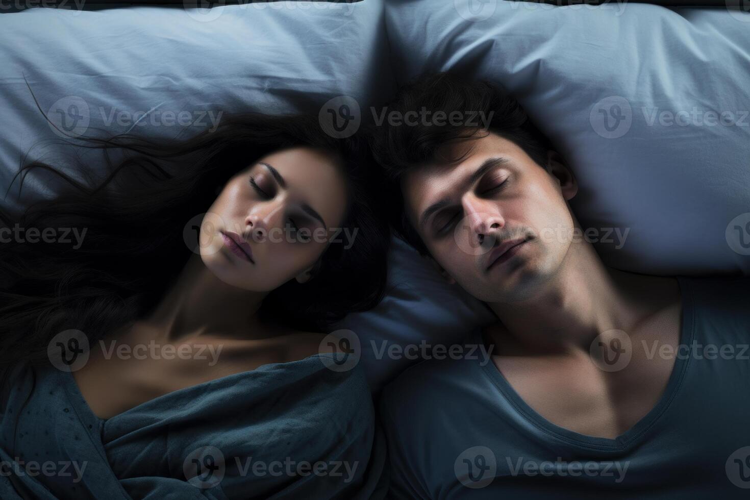 Serene couple sleeping peacefully in bed, embracing restful slumber photo