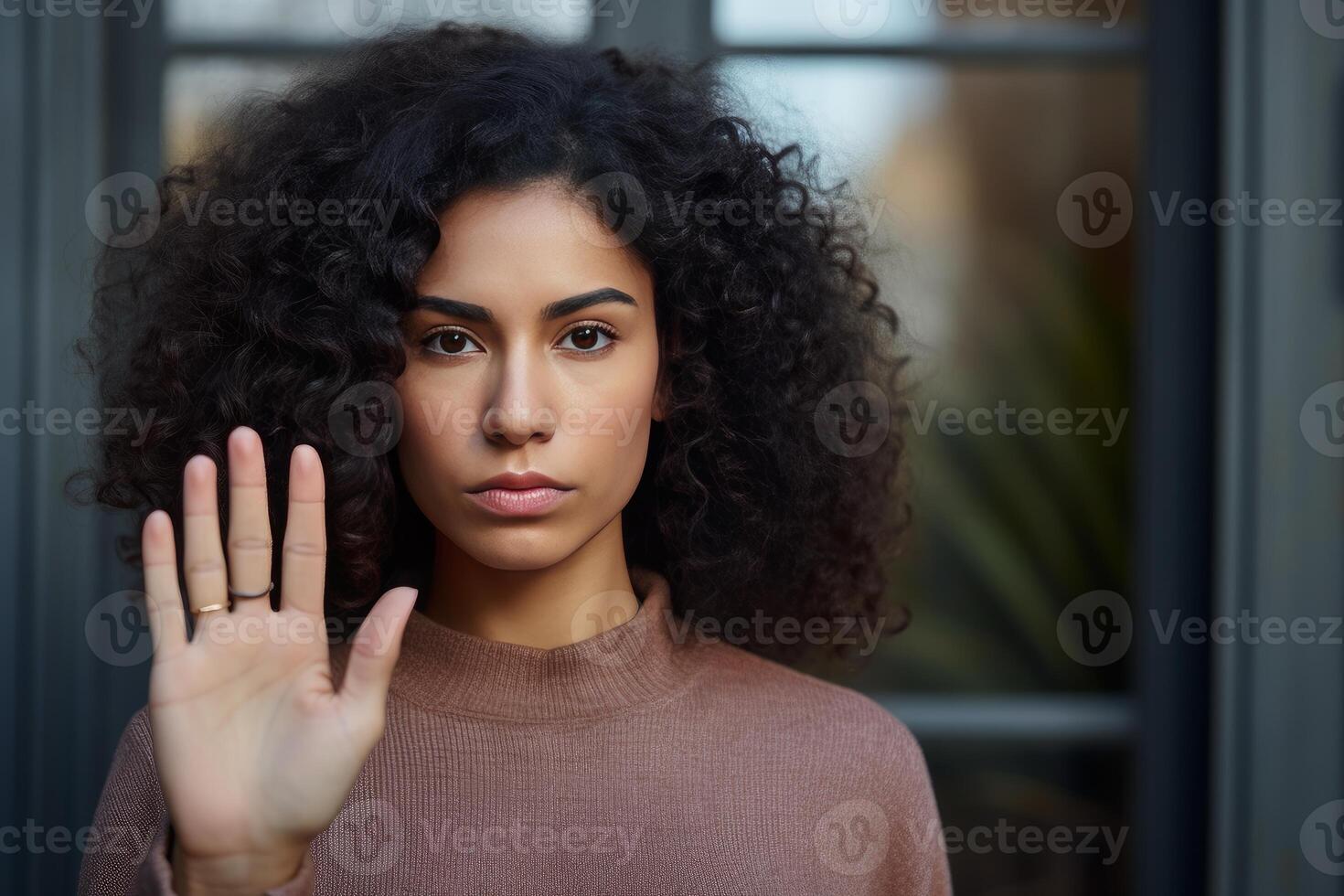Serious young woman making stop sign with hand, refusing abuse photo