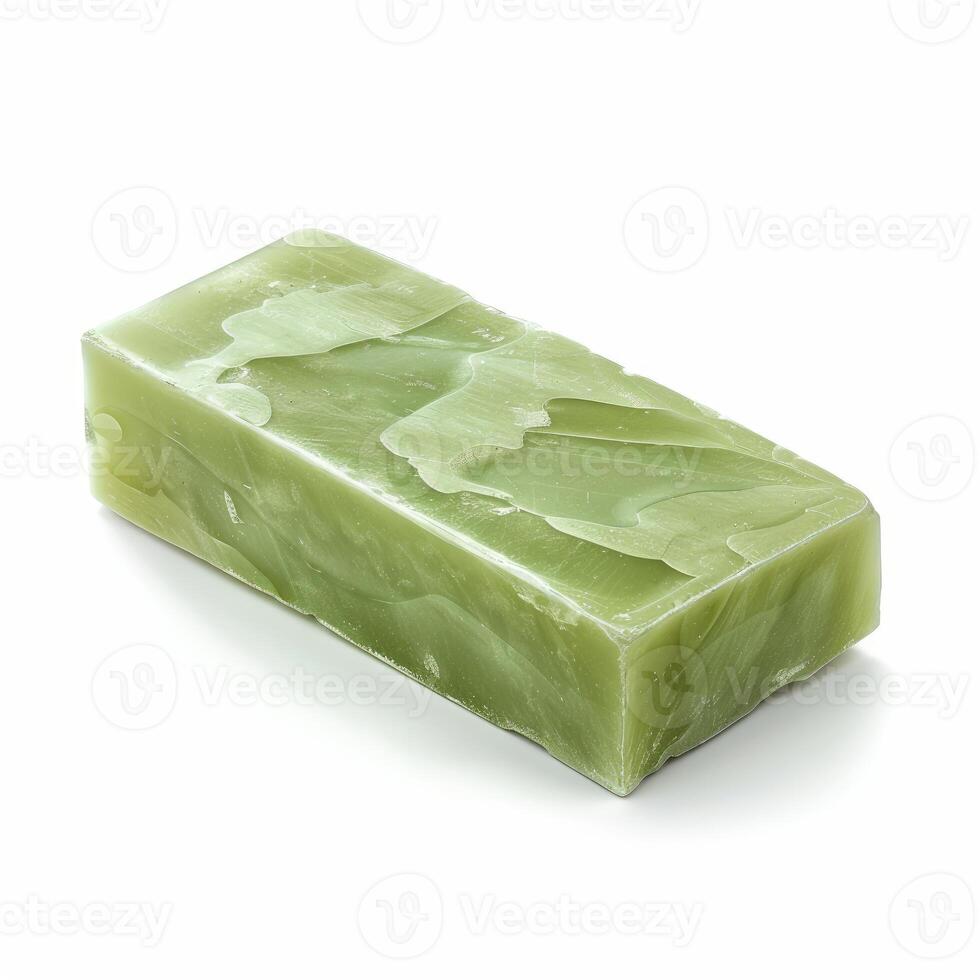 Green soap bar resting on white background photo