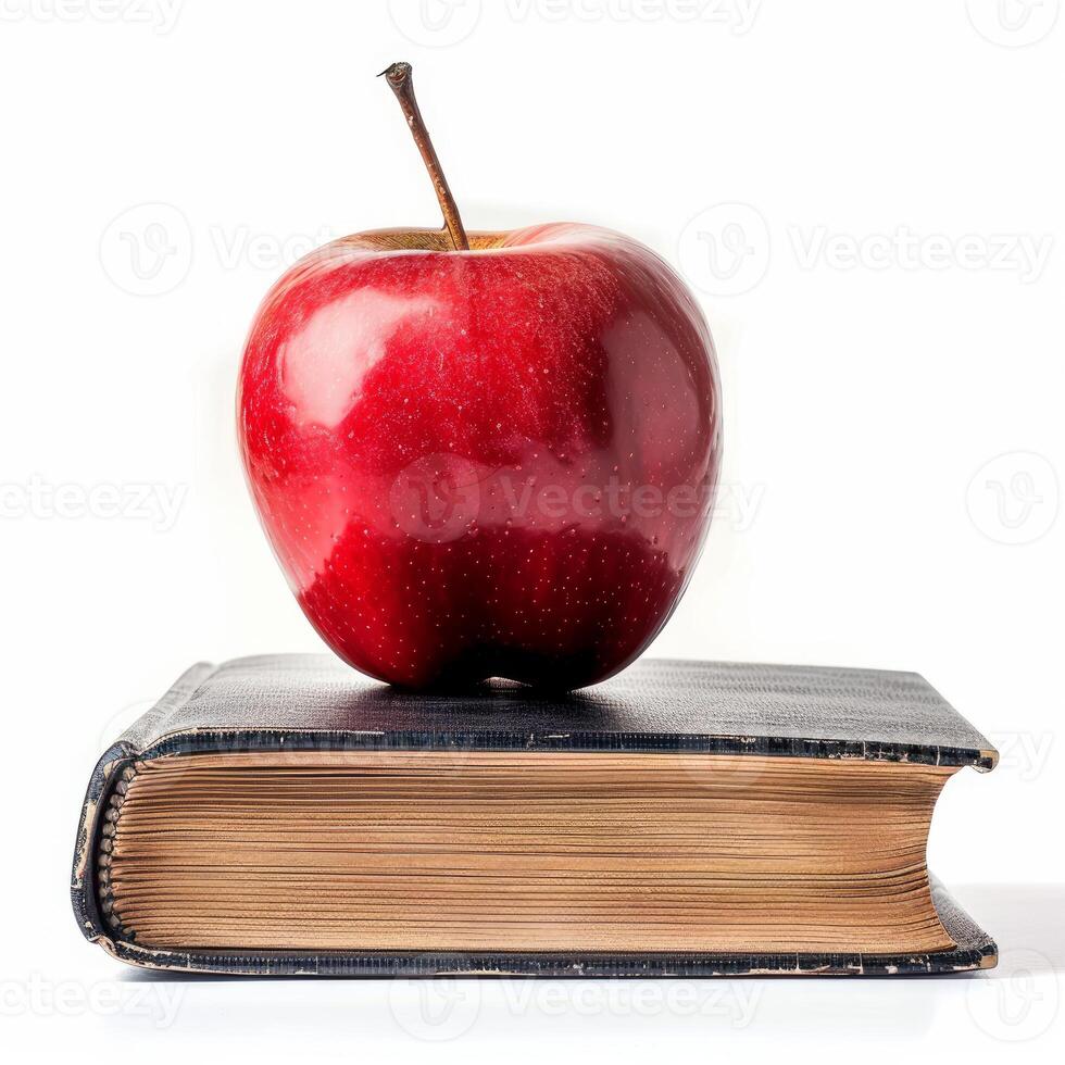 Red apple resting on top of an old book symbolizing education photo