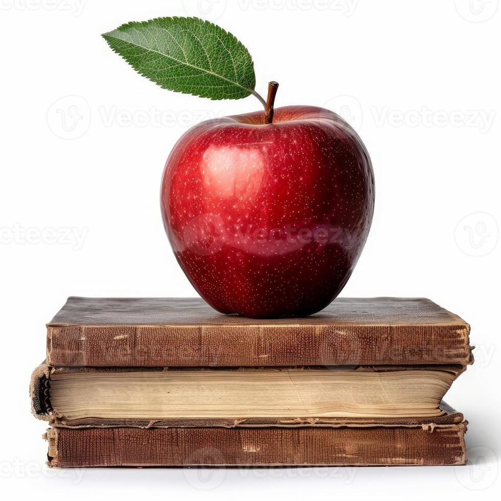 Red apple with leaf sitting on stack of old books symbolizing education photo
