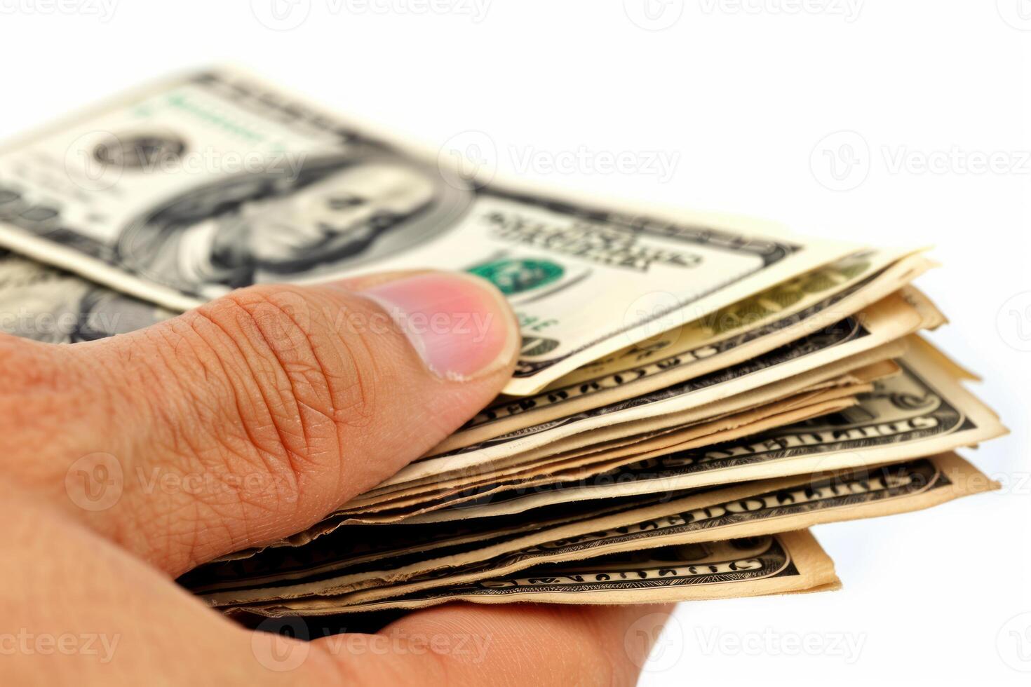 Hand holding and counting one hundred dollar bills on white background photo