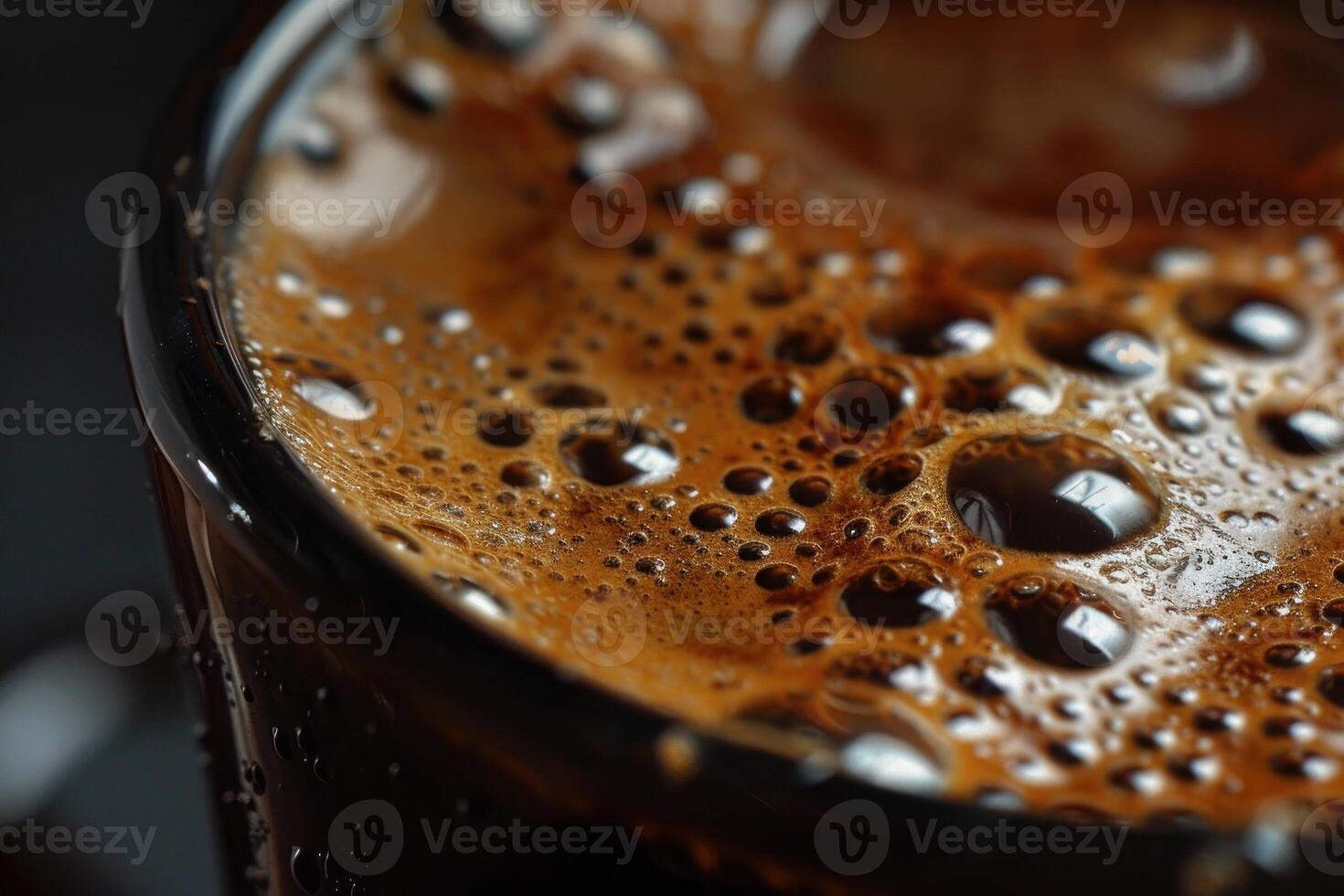 Close up of coffee foam bubbles creating textured surface in cup photo