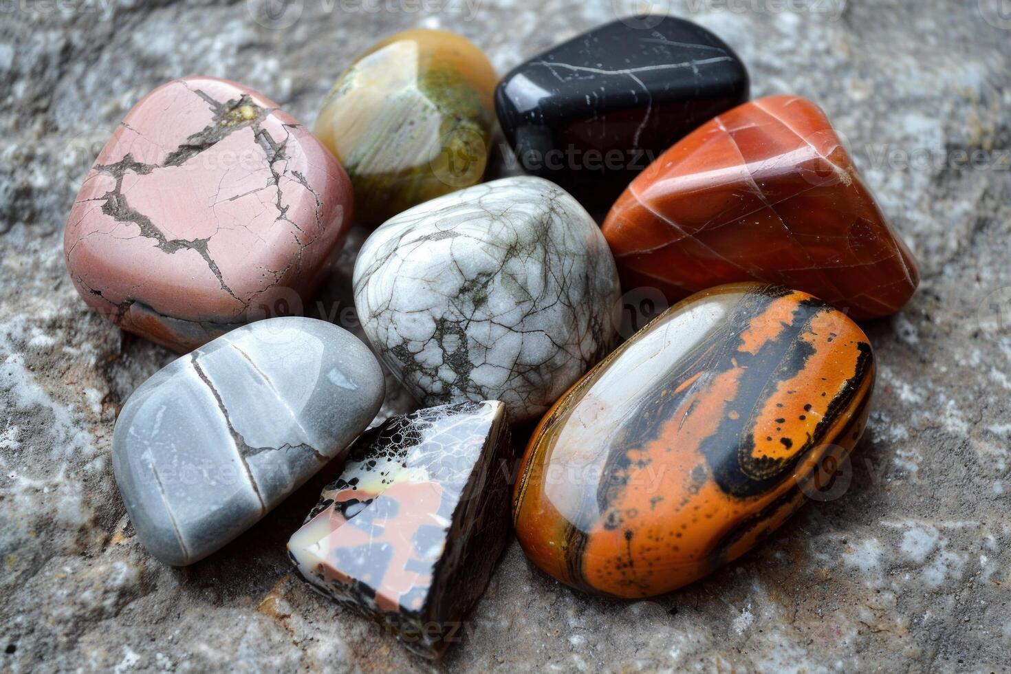 Colorful polished gemstones showing various textures resting on rock photo