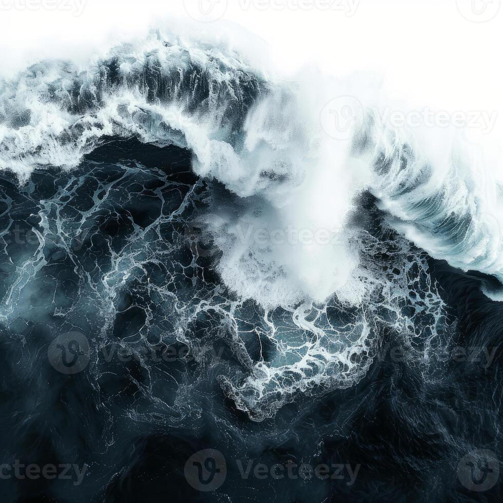 Giant waves crashing in the ocean creating white foam on dark blue water photo