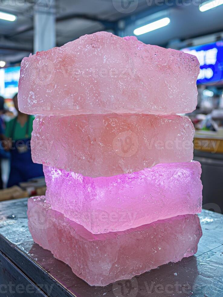 Stack of pink ice blocks on a metal surface photo