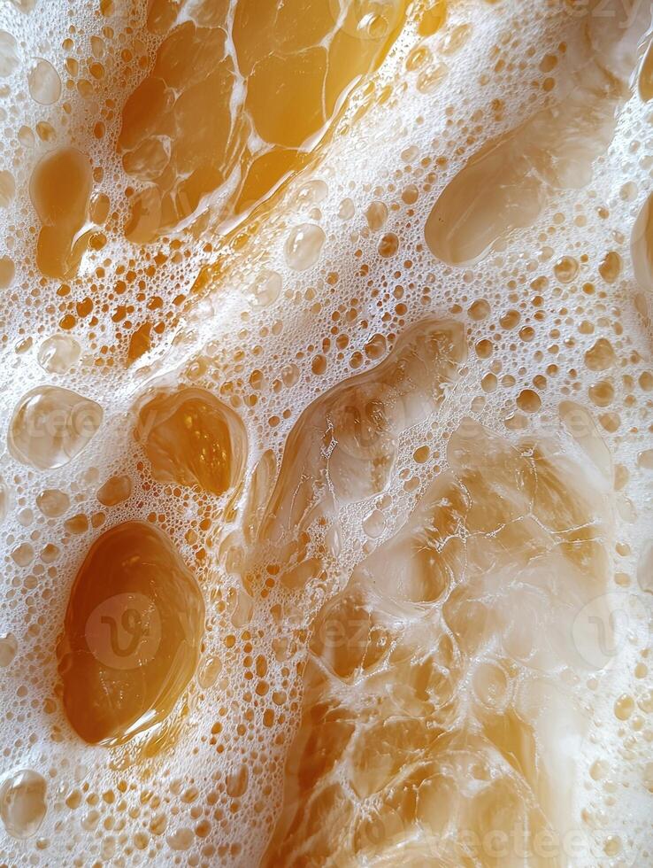 Close up of foamy orange liquid with bubbles photo