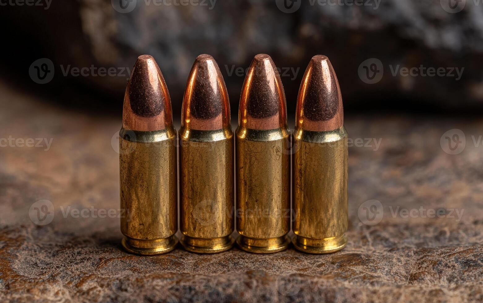 Four 9mm bullets on a rustic surface photo