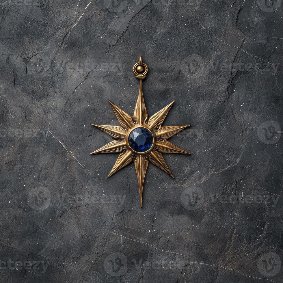 Gold star pendant with blue gemstone on dark background photo
