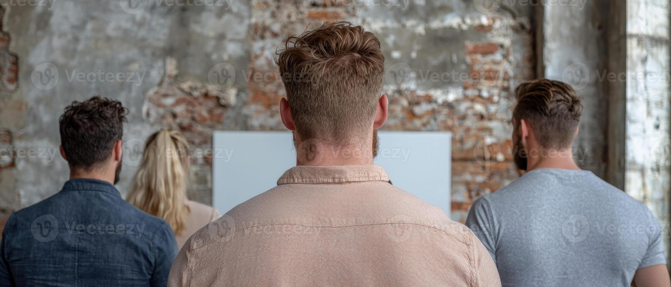 Group of people looking at a blank canvas in a rustic setting photo