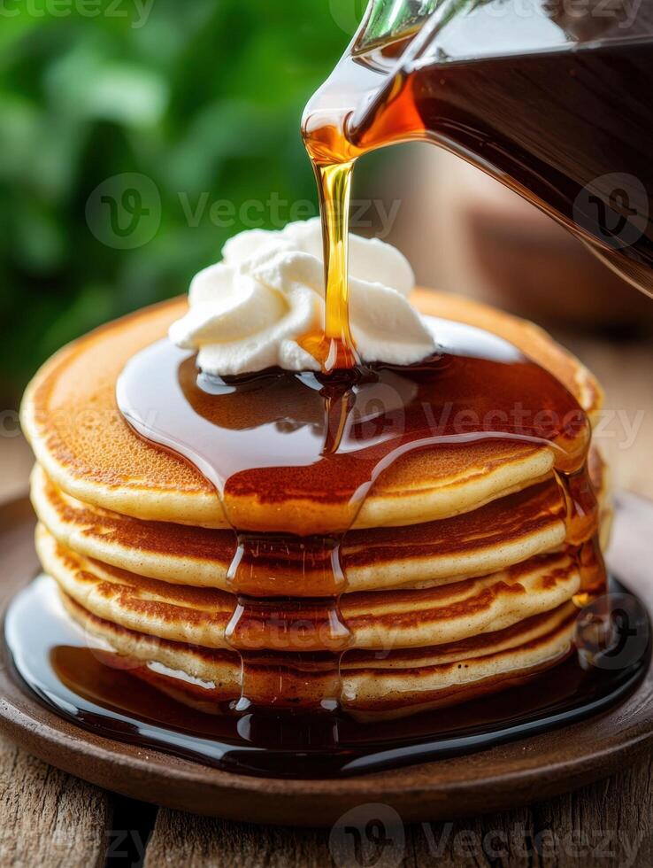 Tasty pancakes with syrup and whipped cream. photo