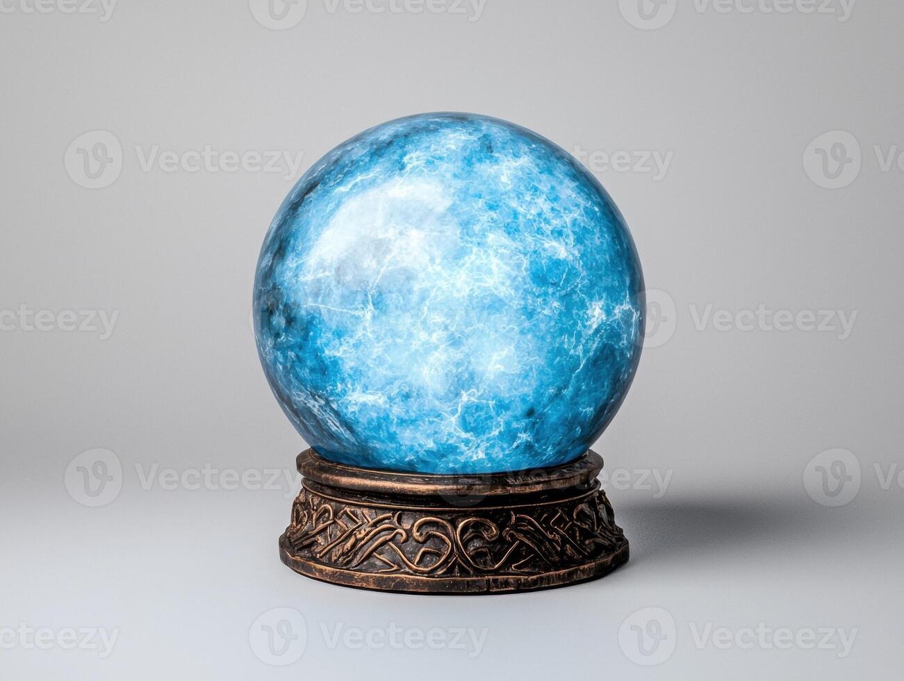 Blue crystal ball on ornate stand photo