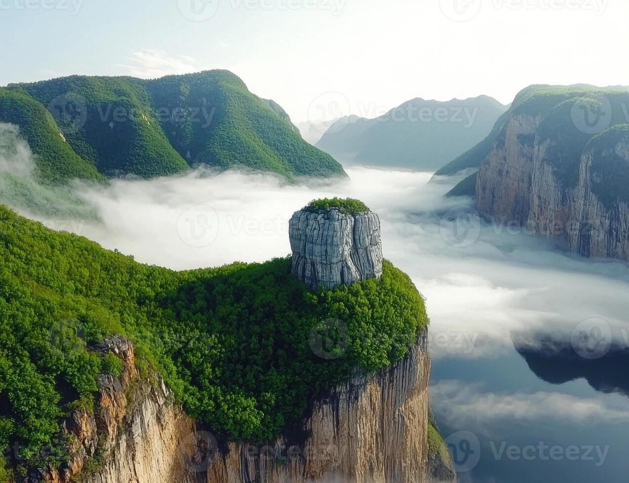 Misty mountain peak with lush green vegetation photo