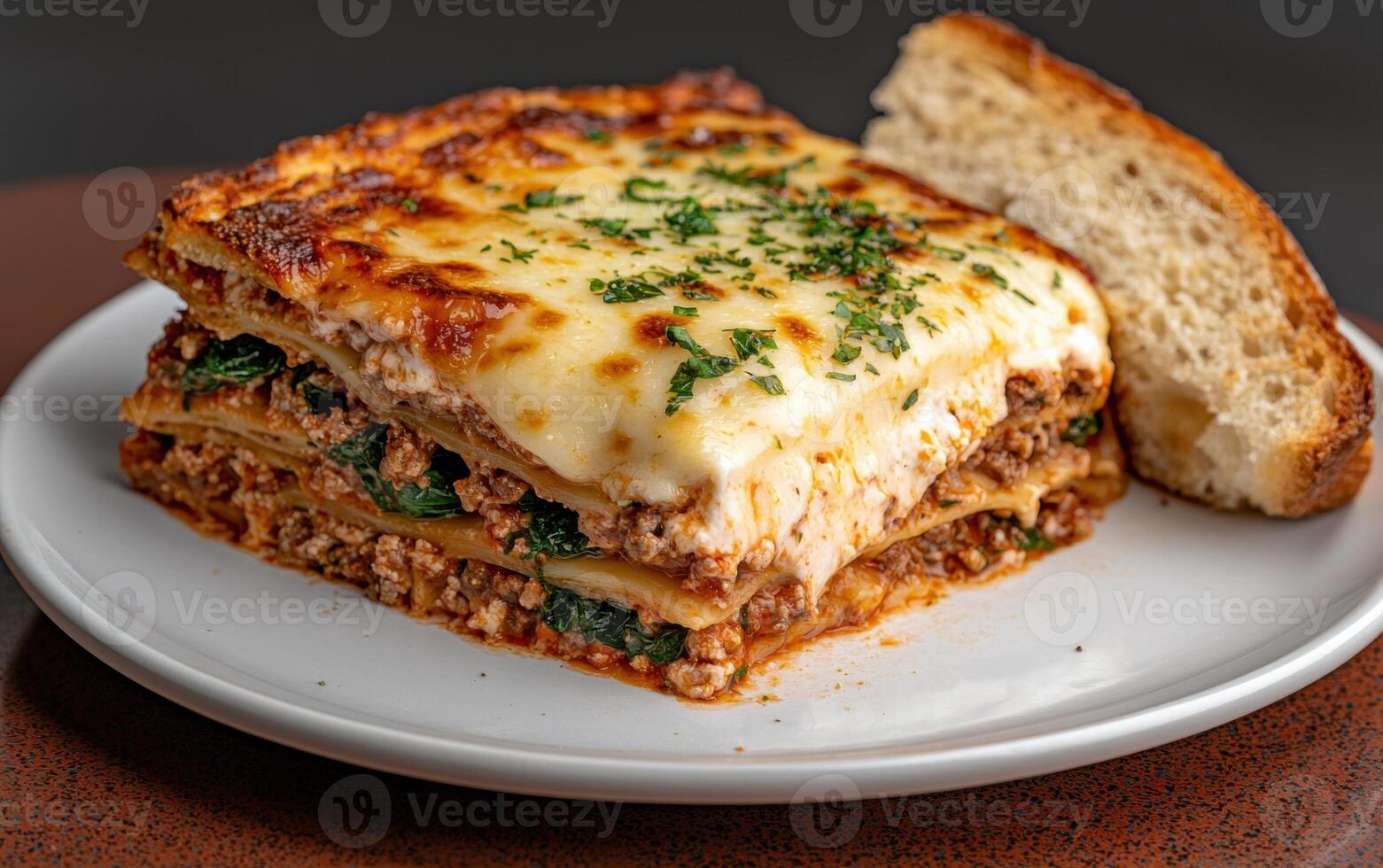 Delicious lasagna with melted cheese and fresh parsley photo