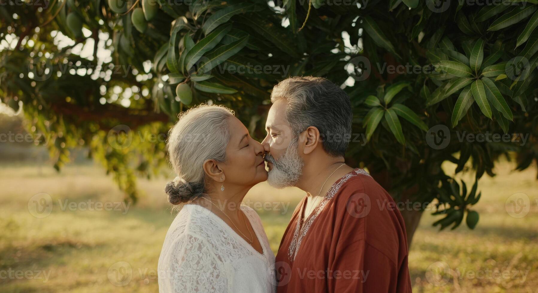 Mature couple enjoying intimate moment in serene park setting at sunset photo