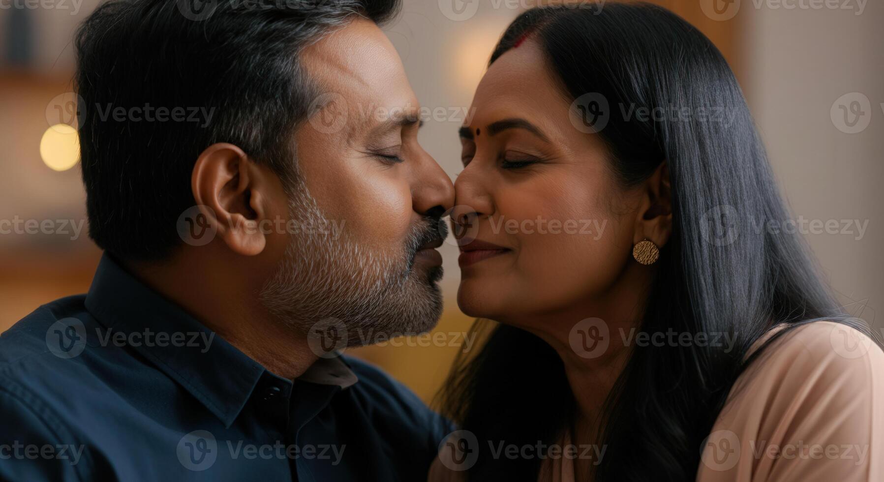 Romantic moment between mature south asian couple expressing love and affection indoors photo