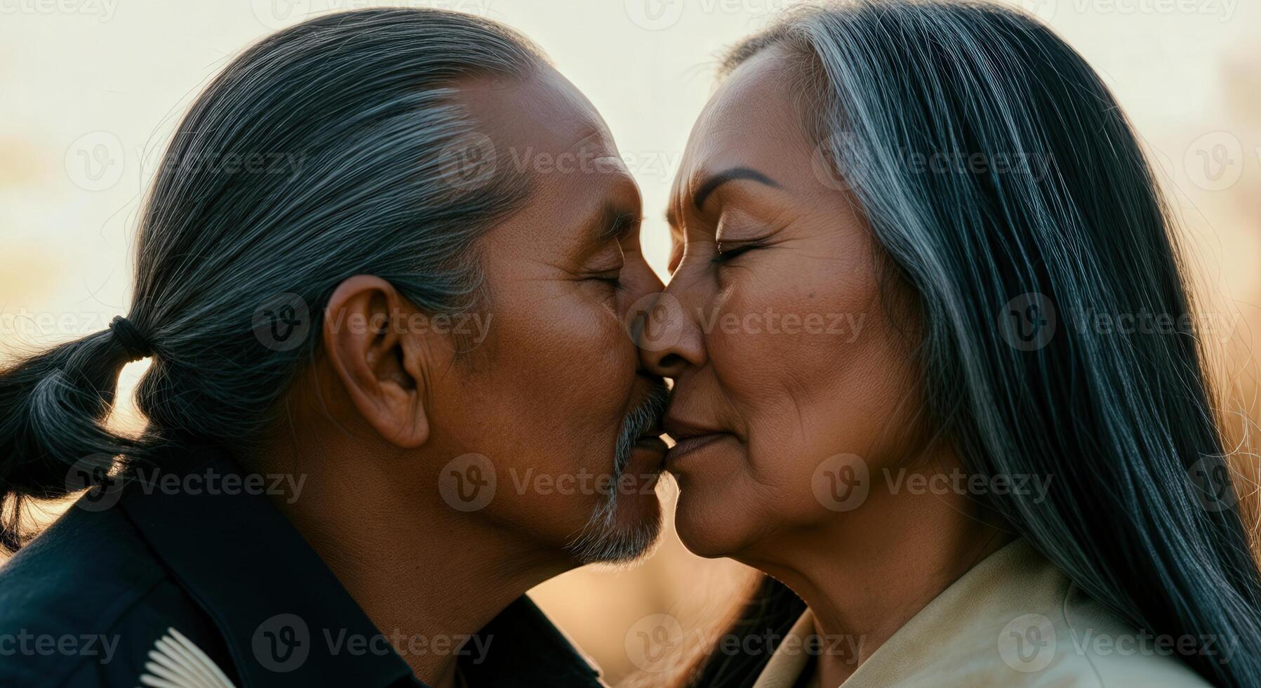 Tender moment between mature native american couple embracing romantic connection photo