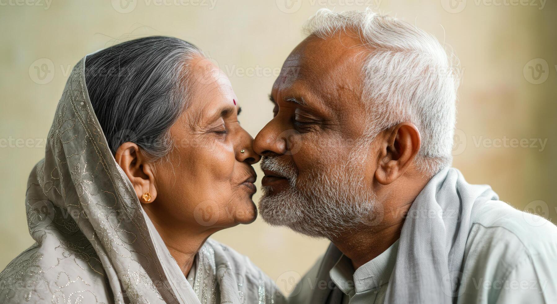 Elderly south asian couple sharing an intimate moment in traditional attire celebrating love photo